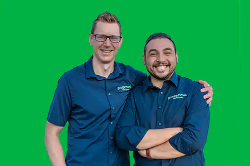 Go Vertical Media Group owners Mark and Robin posing together with a green screen. Go Vertical is a website design company and marketing agency with office space within the EBRC building in St. Thomas Ontario.
